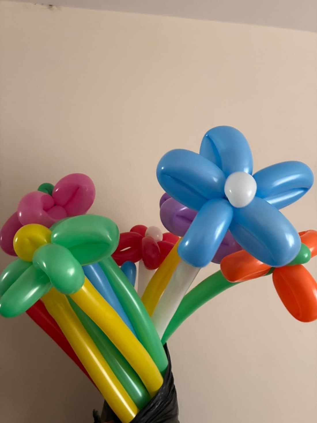 A bunch of twisted balloon flowers in blue, pink, green and orange