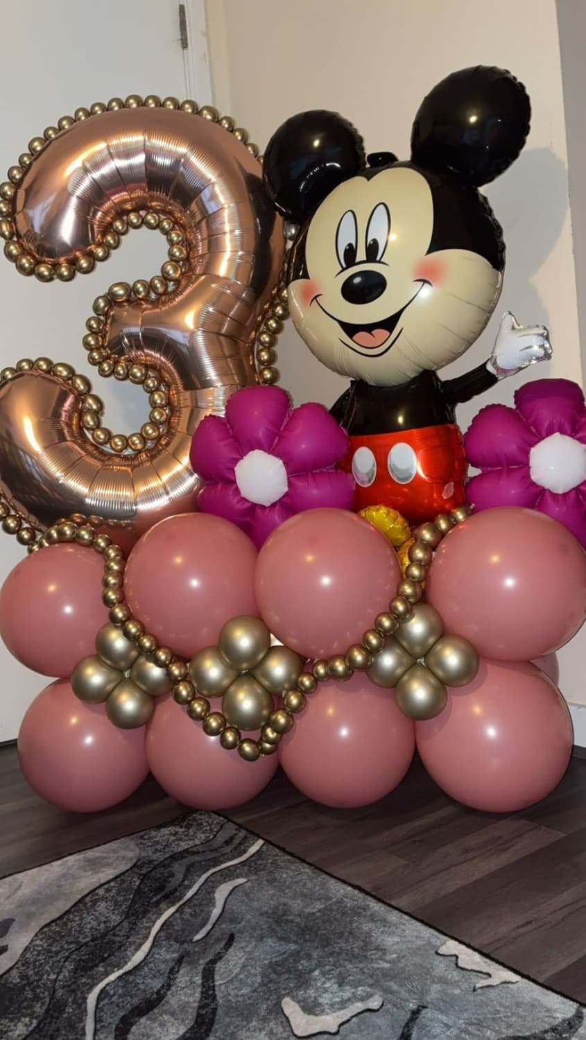 A rose gold number three balloon stack with a Mickey Mouse foil and pink and gold balloons