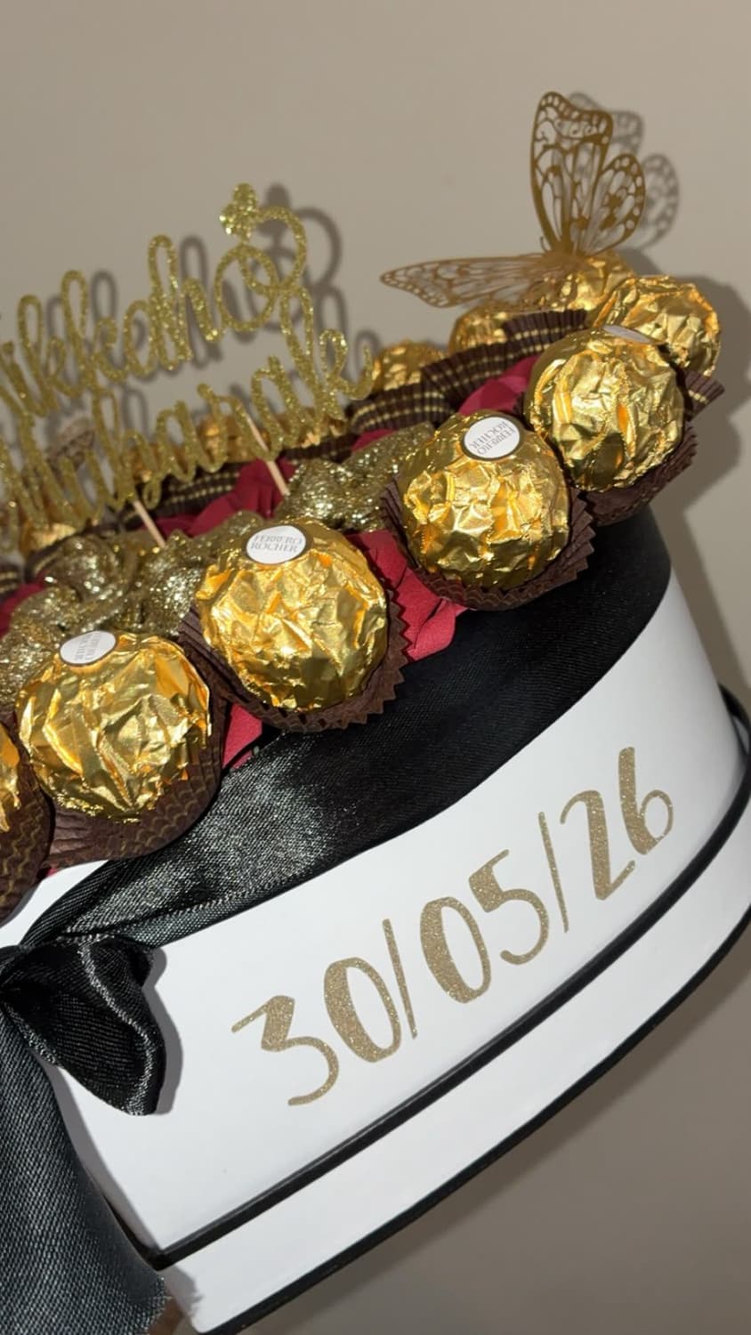 Close up of Ferrero Rocher around the edge of a heart box, with the date 30/05/26 in gold glitter